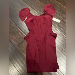 Fitted structured red dress with capped sleeves and low back
